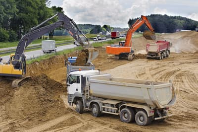 A building site with a variety of construction vehicles at work